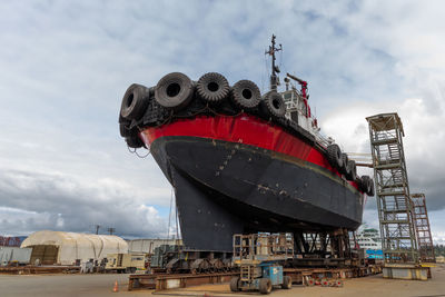 Large tug boat in dry dock getting repairs