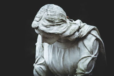 Close-up of statue against black background