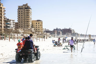 People in city against clear sky