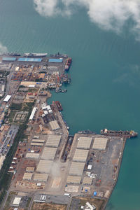 High angle view of buildings by sea against sky