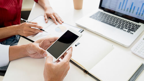 Midsection of woman using mobile phone
