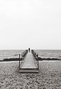 Pier on sea against clear sky