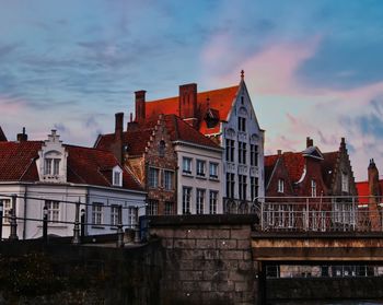 Low angle view of buildings in city at sunset