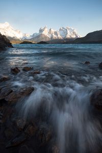 Scenic view of sea and mountains against sky