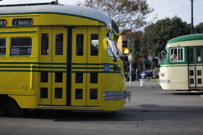 Green tramway on street in city