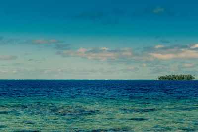 Scenic view of sea against blue sky