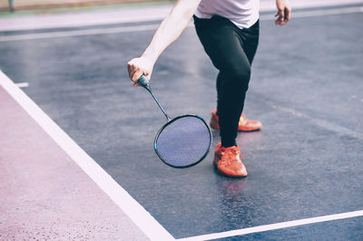 Low section of woman playing badminton