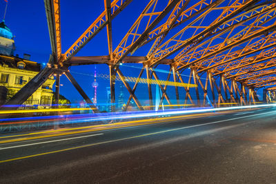 Light trails on road against sky at night