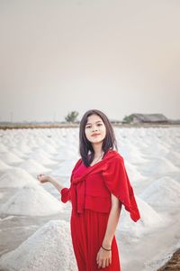 Portrait of beautiful young woman standing outdoors