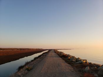 Scenic view of sea against clear sky during sunset