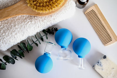 Flatlay spa items. massage jars and a brush. body and face care. massage cups for the face