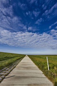 Empty road along countryside landscape