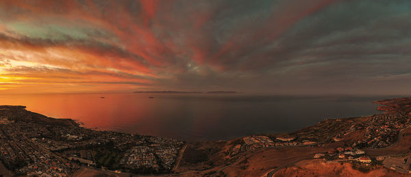 Scenic view of sea against romantic sky at sunset