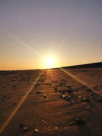 Scenic view of desert against sky during sunset