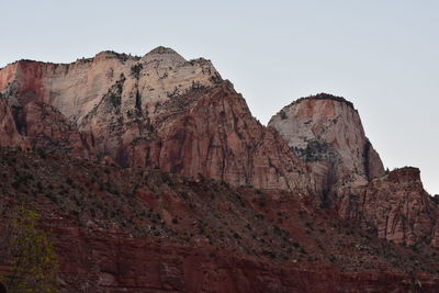 Low angle view of rocky mountains against sky