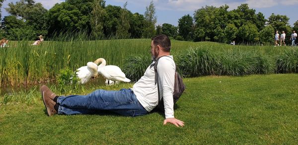 Rear view of person with dog at park