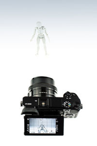 Low angle view of camera against white background