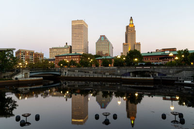 River walk in downtown providence with buildings reflected in the river