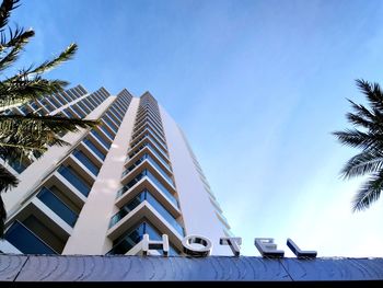 Low angle view of modern building against blue sky