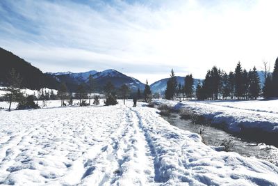 Snow covered landscape against sky