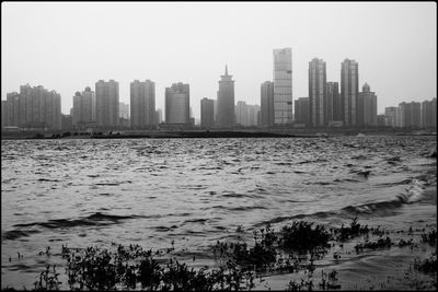 Panoramic view of sea and buildings against clear sky