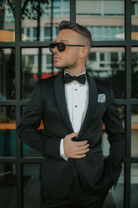 Young man wearing sunglasses standing outdoors