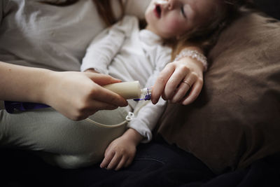 Mother preparing feeding tube for disabled child at home