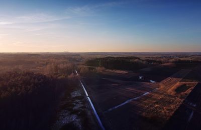 Aerial view of cityscape against sky during sunset