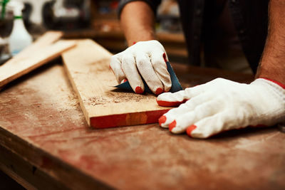 Midsection of man working on table