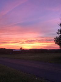 Scenic view of field against sky during sunset