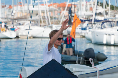 Rear view of man on sailboat sailing in sea