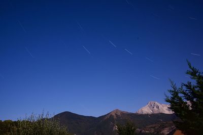 Low angle view of mountain against blue sky