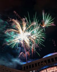 Low angle view of firework display at night