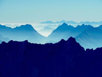 Scenic view of mountains against clear blue sky