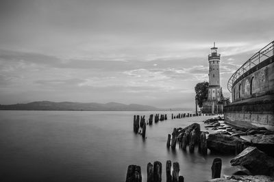 Bridge over sea against buildings