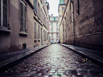 Surface level of narrow alley amidst buildings