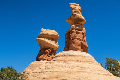 Low angle view of rock formation against blue sky