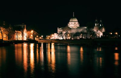 Night scene of galway cathedral by corrib river in ireland