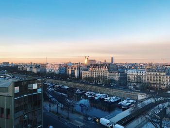 Paris cityscape. high angle view of buildings and canal against sky at dusk, horizon over the city 