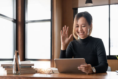 Young woman using laptop at table