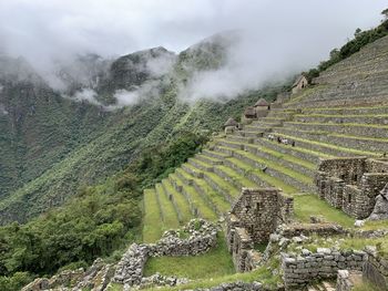 Scenic view of landscape and ruins against sky