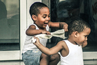 Friends standing by mirror
