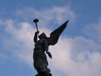 Low angle view of statue against sky