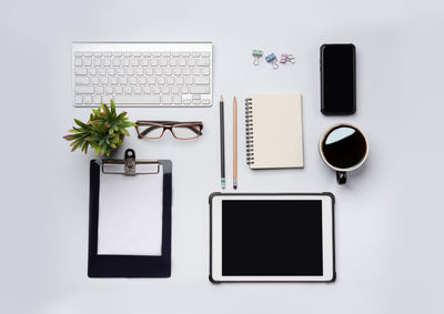 Directly above shot of laptop on table against white background