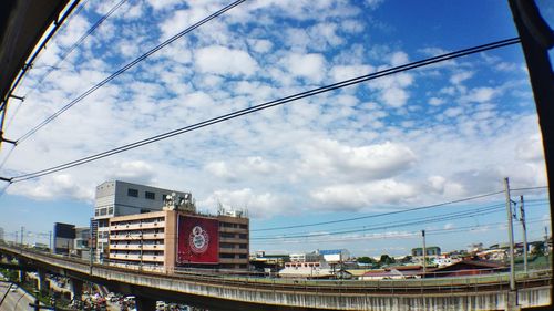 Low angle view of buildings against cloudy sky