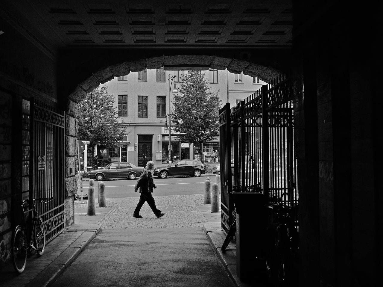 architecture, built structure, building exterior, walking, full length, men, lifestyles, street, city, person, building, city life, arch, rear view, the way forward, leisure activity, bicycle, window