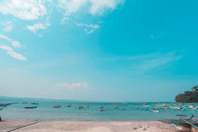 Scenic view of beach against blue sky