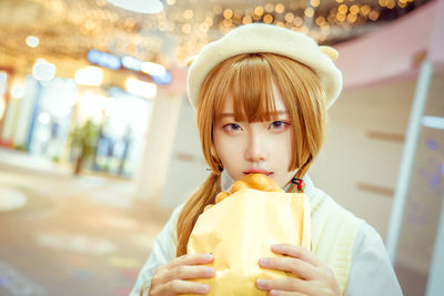 Portrait of young woman eating food