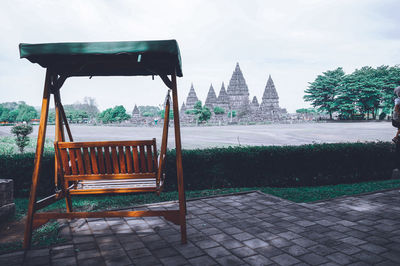 Empty seats in park against buildings