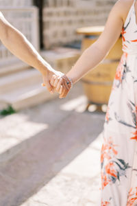 Midsection of woman holding hands